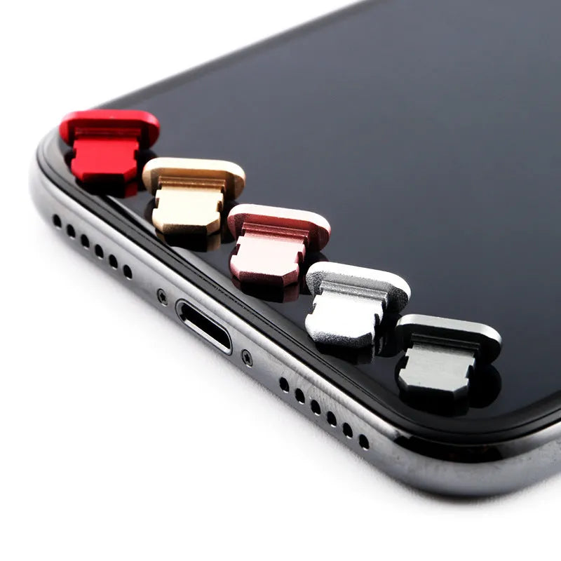 Aluminium alloy iPhone charging port dust plug in various colours including gold, silver, blue, and rose gold.