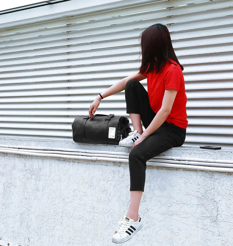 Black waterproof sports bag with separate shoe compartments and diagonal straps in two size options