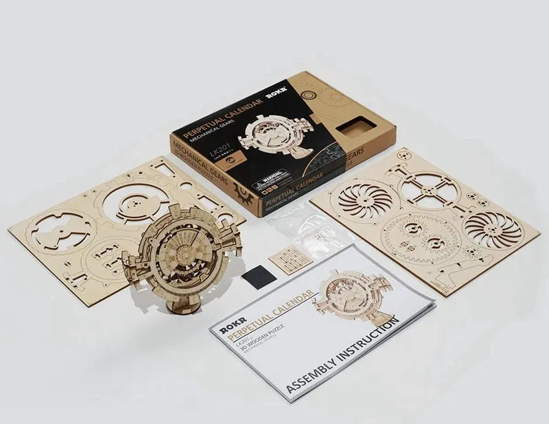 Flat-packed wooden 3D puzzle film projector with visible gear wheel assembly and hand crank