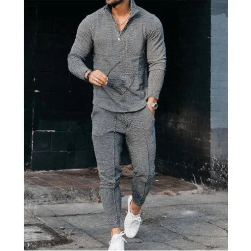 Men's grey sports and leisure loose suit set with polyester top and pants on a plain background