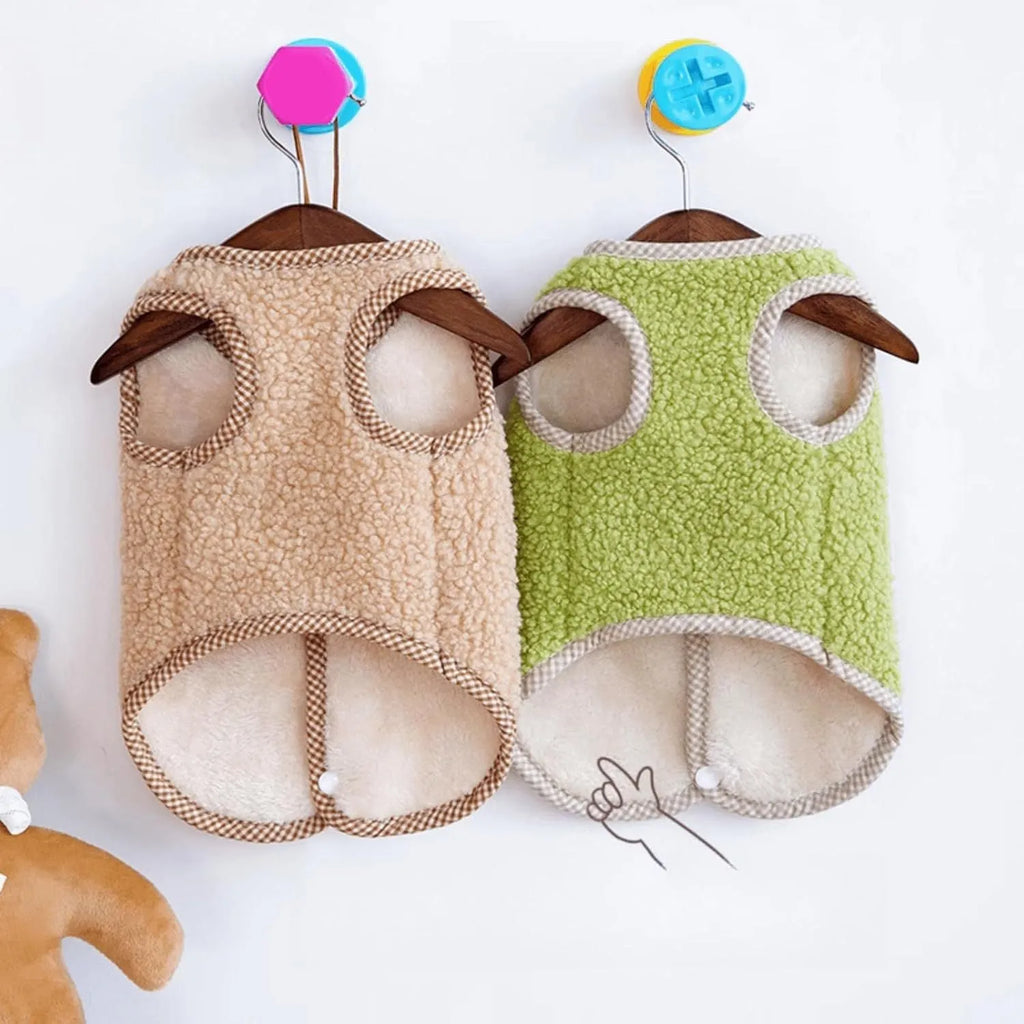 Green coral fleece dog vest with leash ring on a small dog, showing winter outfit.