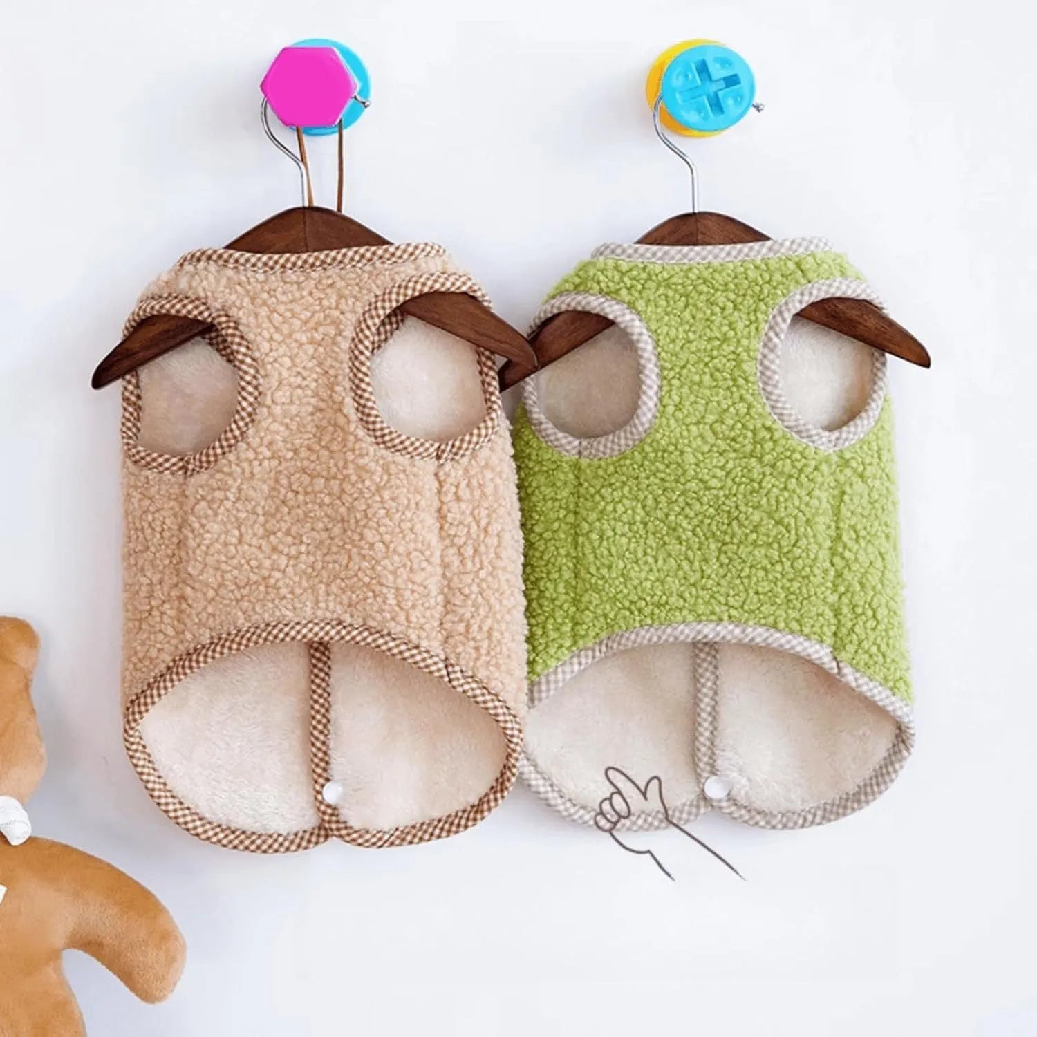 Green coral fleece dog vest with leash ring on a small dog, showing winter outfit.
