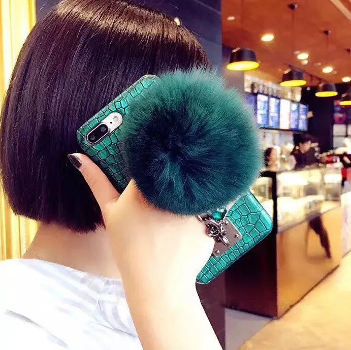 PU leather iPhone case with fox fur ball and rhinestone studs, compatible with iPhone 6, 6s, 7, 8, Plus, and X.