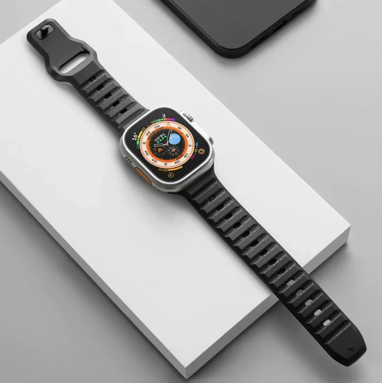 Fluoro rubber Apple Watch replacement strap with T buckle in one of six colours on a wrist.