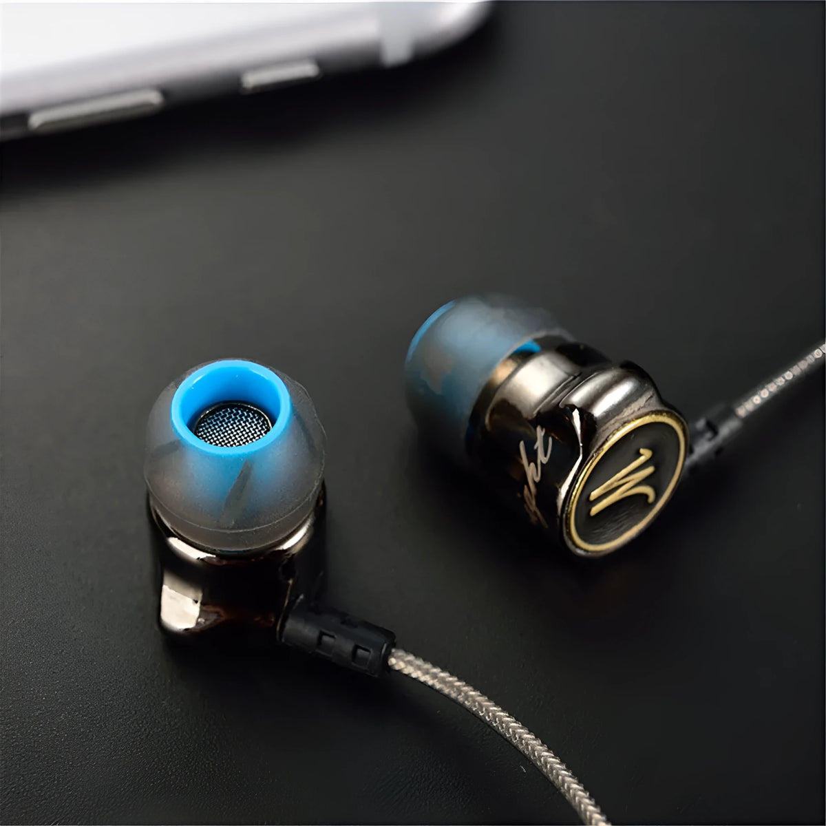 DM7 in-ear headphones in black with silicone earplugs and TPE cable, side view