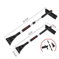 Car deicing shovel with black ABS plastic shovel head and brush, telescopic handle extended, on a windscreen with frost