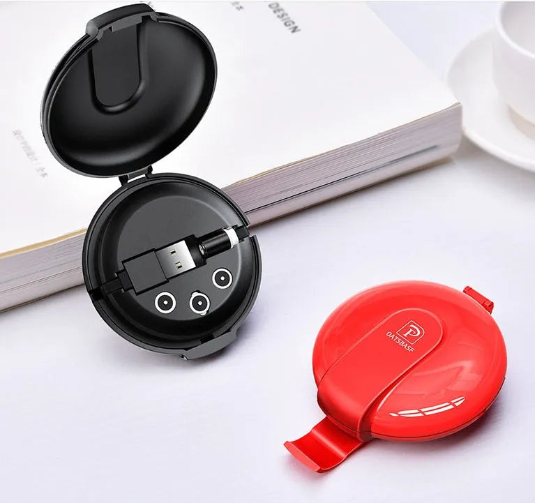 Black magnetic 3-in-1 car phone holder and portable charger with retractable cable on a car dashboard.