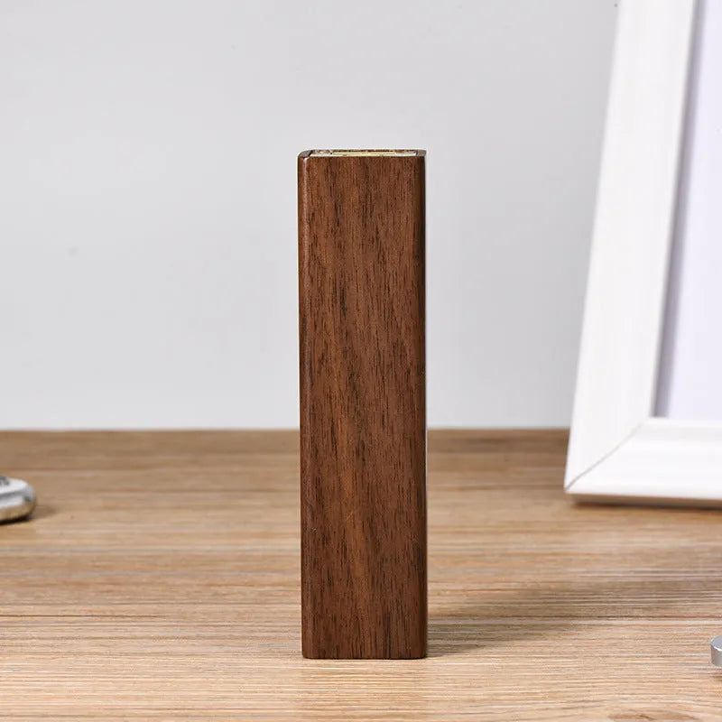 Portable power bank with brown walnut wood shell showing charging ports