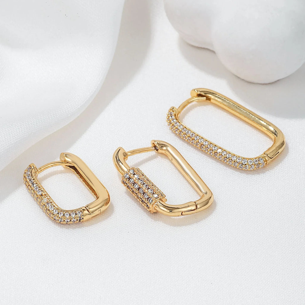 Three geometric copper ear clips with micro inlaid zircon stones in gold and white gold finishes