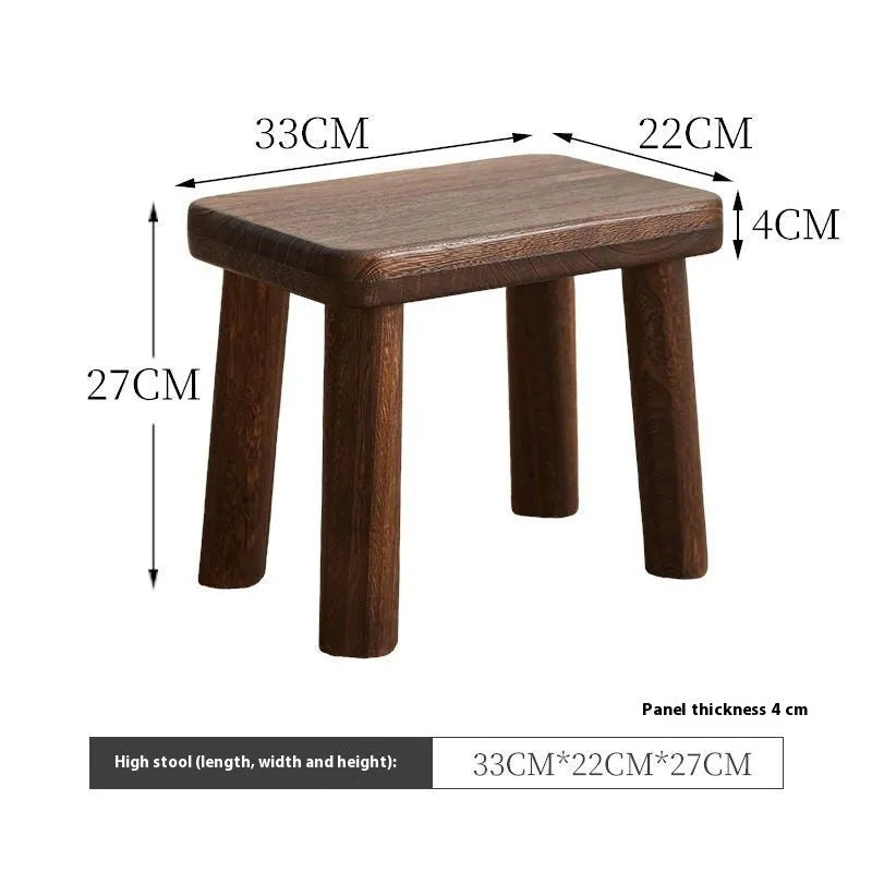 Distressed wooden shoe changing stool with bracket construction in living room setting