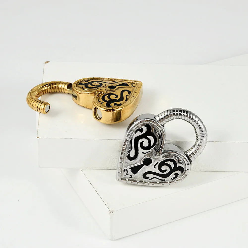 Close-up of a stainless steel heart-shaped earring with a gold-coloured electroplated finish.