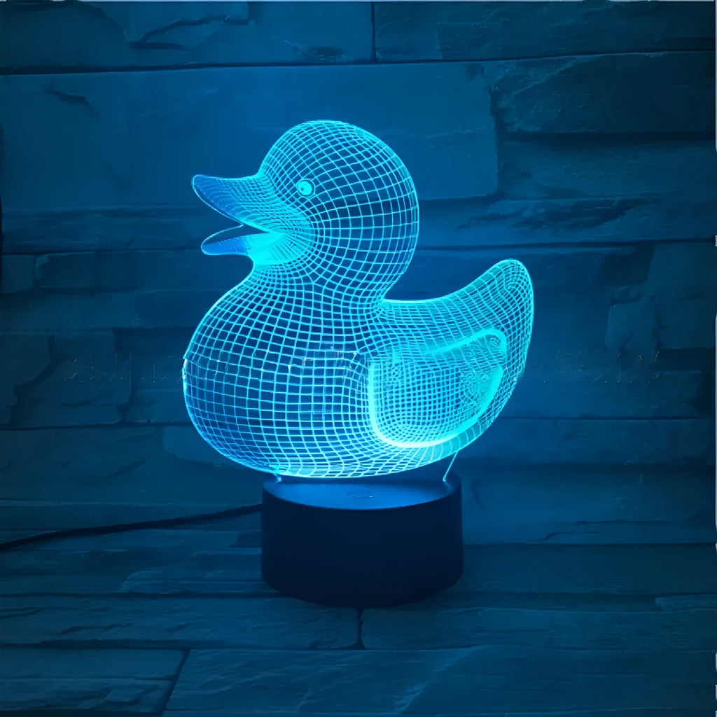 Little yellow duck 3D night light with colour-changing LED display on an ABS base, showing remote control.