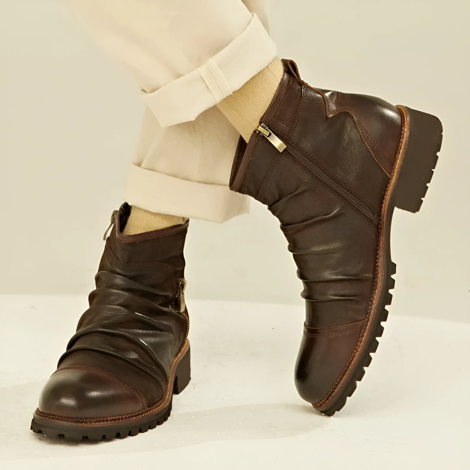 Black side-zip cowboy boot with round toe and a mid-height horseshoe heel on a plain background.