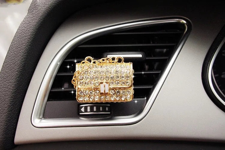 Alloy car perfume clip with liquid fruity scent attached to air vent in various cartoon styles