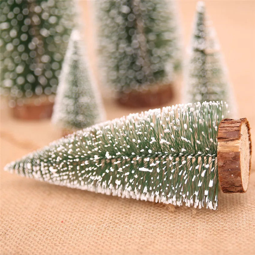 Set of artificial Christmas pine needle trees in green and white, heights 10cm to 30cm, on a tabletop