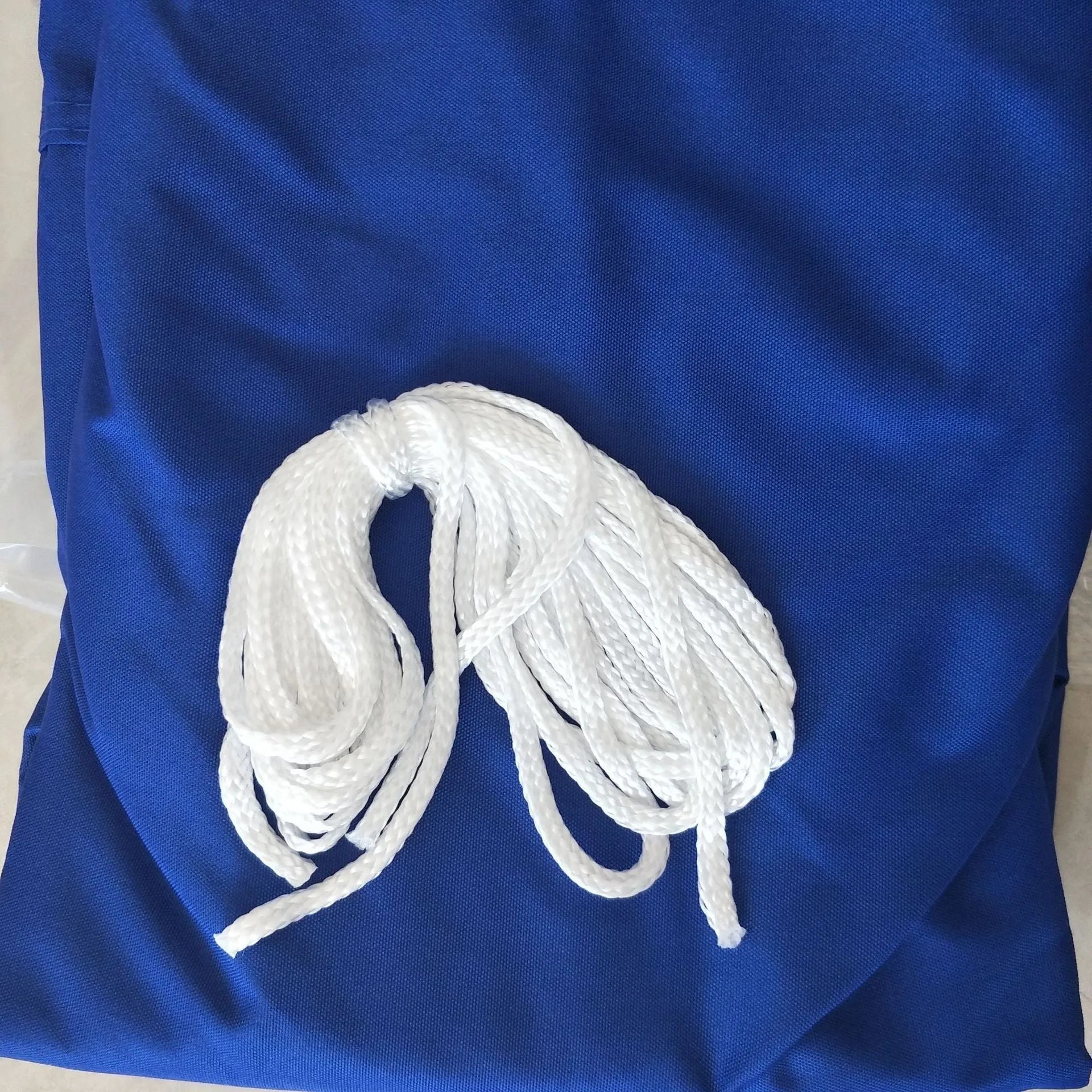 Blue polyester shade sail with curved square shape providing 3x4 metre outdoor coverage