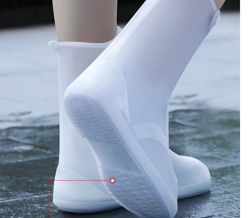Women's white PVC high top reusable waterproof shoe covers shown on feet