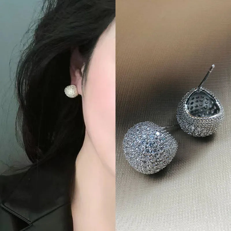 Women's gold and white drop-shaped ear clip earrings with full diamond embellishment and geometric golden beans design