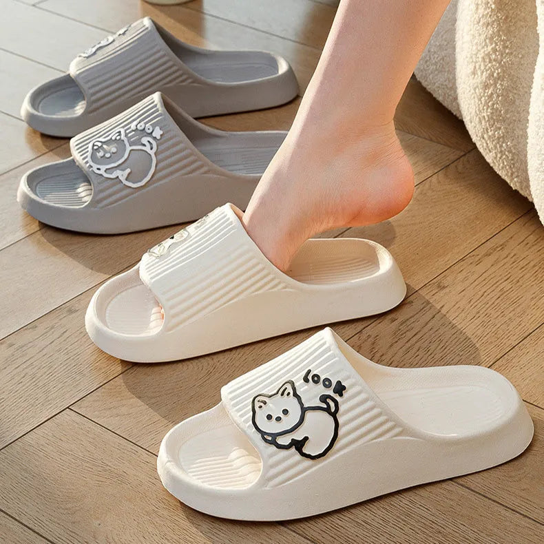 Women's green cat slippers with thick platform sole and flip-flop design on a white background.