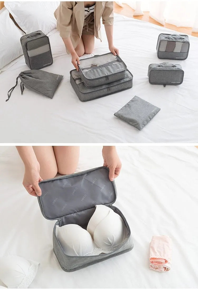 Seven-piece waterproof travel tote bag set in black and gray with six sorting bags and cation hardware