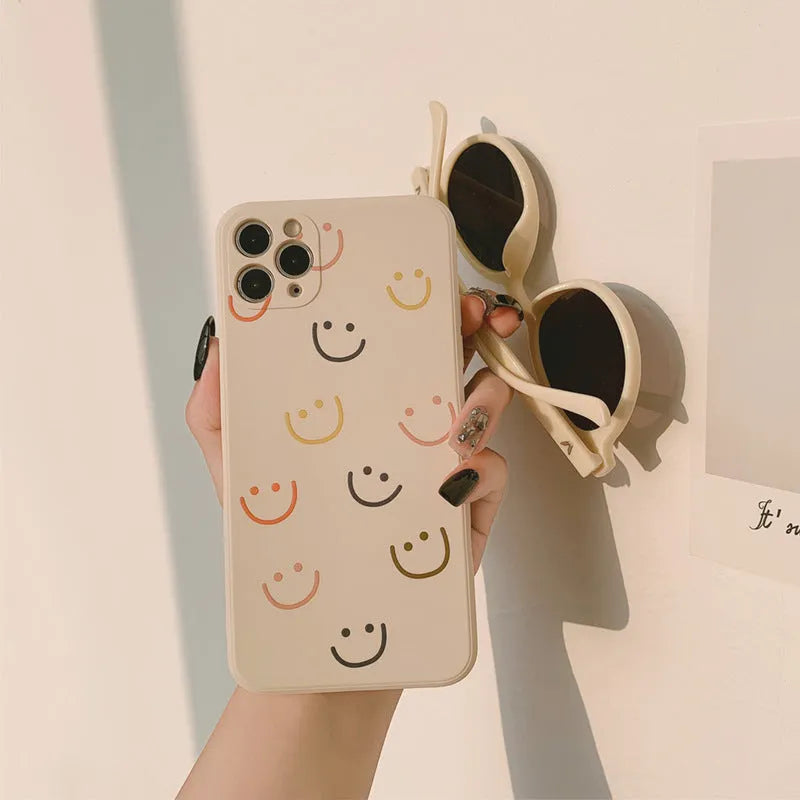 Simple silicone iPhone case with painted graffiti and stripe designs on a TPU back cover.