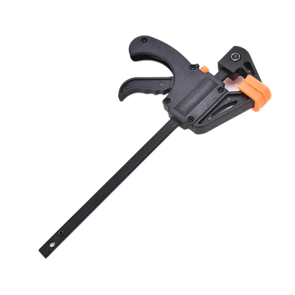 Black woodworking F clip 4 inch with plastic body and carbon steel rod on wooden board