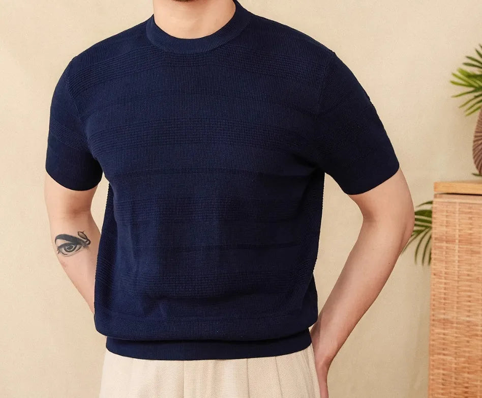 Men's off-white pure cotton short sleeve T-shirt with a round neck on a hanger.