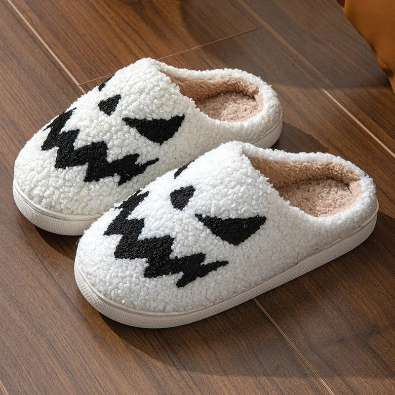 Halloween couple slippers with black and orange ghost face embroidery on suede upper and PVC sole.