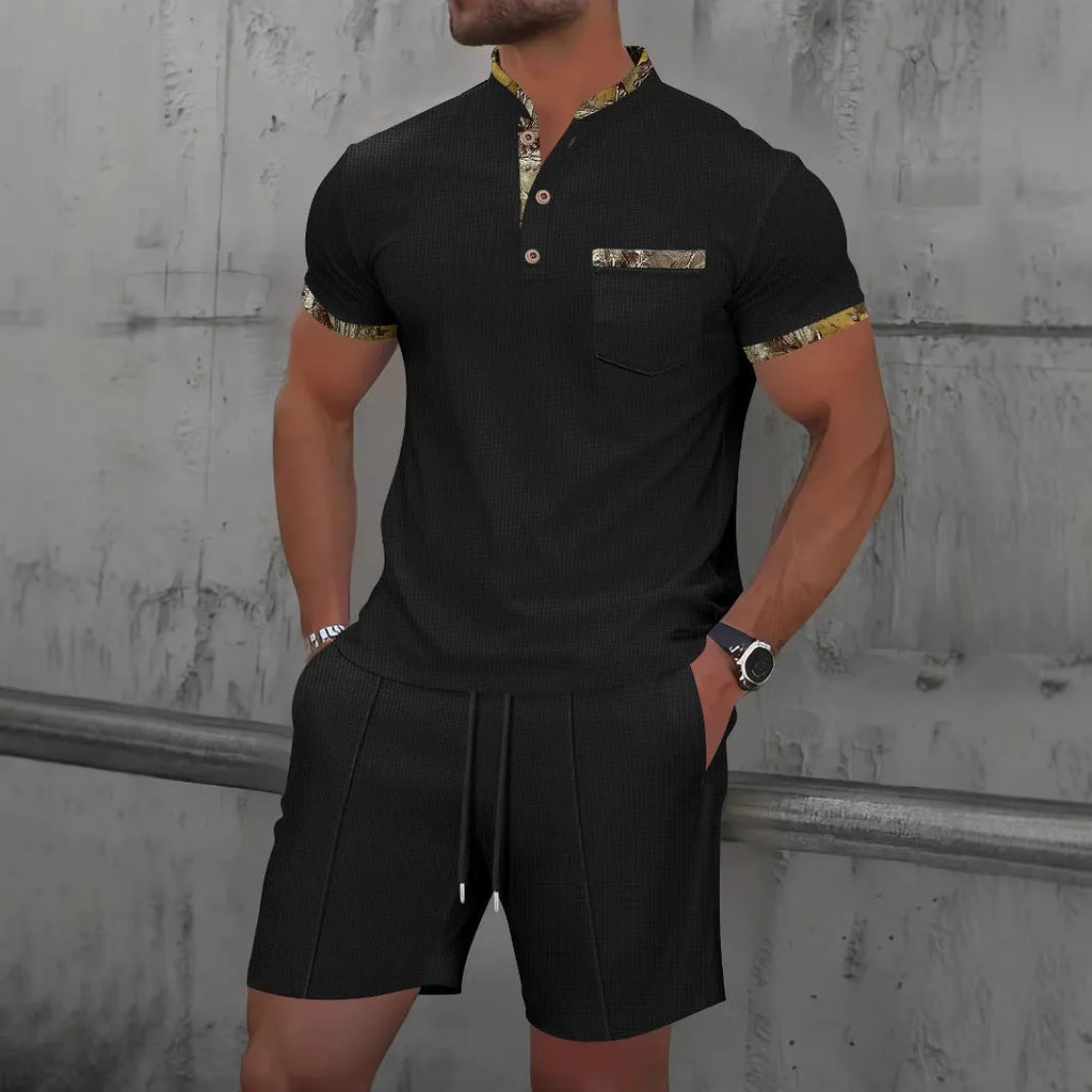 Man wearing a grey short sleeve zippered polo top and matching shorts, a casual cotton blend suit set.