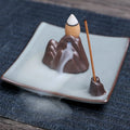 Square purple clay ceramic reverse flow incense burner with lotus and plum blossom decoration.