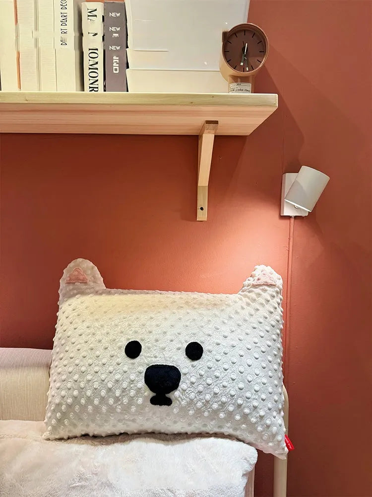 Grey and white West Highland terrier puppy-shaped dog pillow on a sofa.