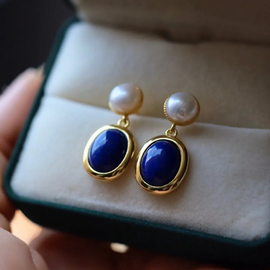 A pair of simple sterling silver stud earrings with a lapis lazuli pearl colour and auspicious patterns.