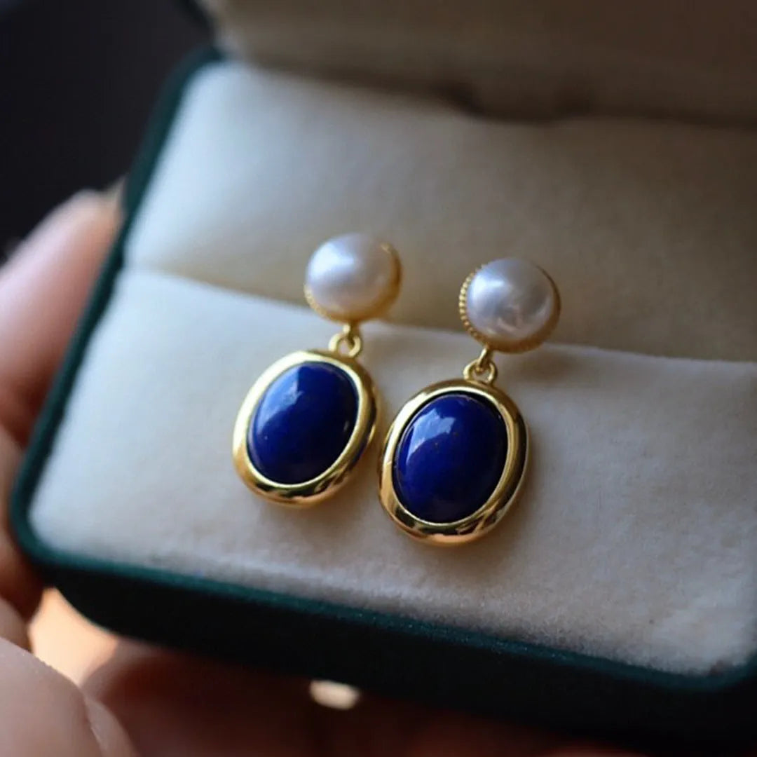 A pair of simple sterling silver stud earrings with a lapis lazuli pearl colour and auspicious patterns.