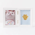 Solid wood palm print photo frame kit with gold paint, two 100g seal paste packs, brush, and colour box.