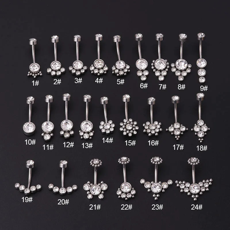 Gold stainless steel belly button ring with clear artificial gemstone inlay on white background