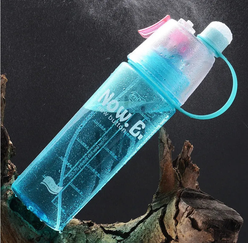 Portable mist spray sports water bottle with transparent body, handle, and press-to-spray mouth