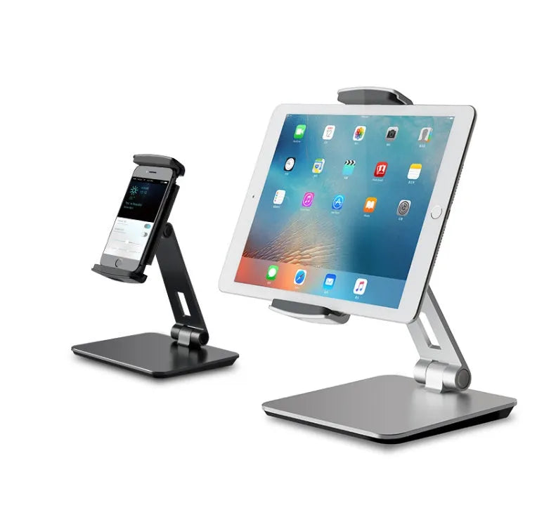 Silver aluminium folding phone and tablet stand on a desk, holding a tablet