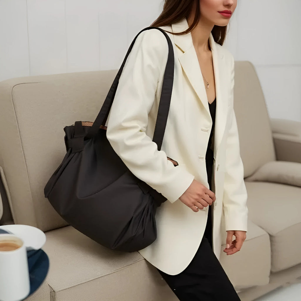 Women's black crossbody travel bag with expandable compartments made from waterproof Oxford cloth