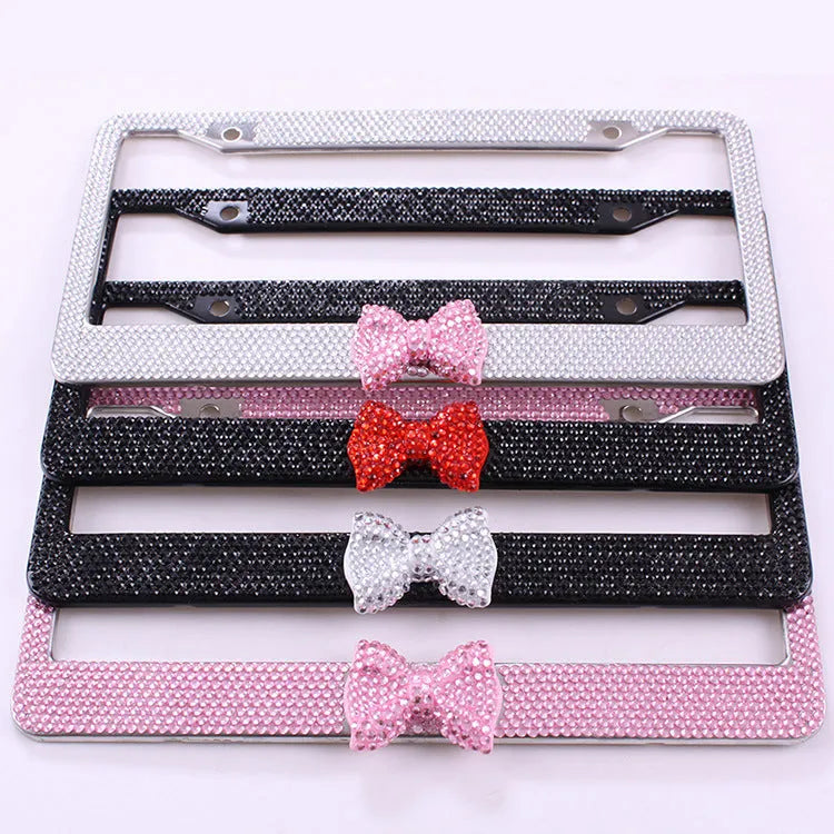 Stainless steel rhinestone license plate frame with hand-set diamonds, 31x6x1.5cm, in black, pink or white.