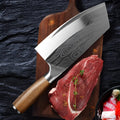 A stainless steel kitchen knife with a 320mm blade on a cutting board.