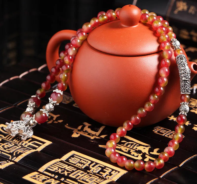 Watermelon crystal bracelet with Chinese knot design showing geometric natural stone beads