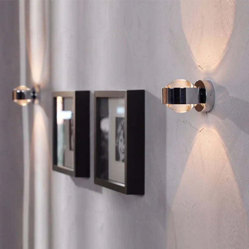 Modern small wall lamp in chrome finish for bedside or hallway lighting