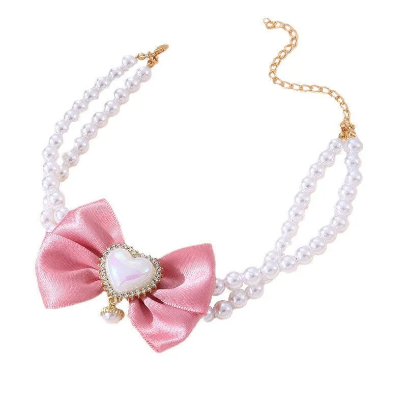 Heart shaped princess style pet necklace with pearl beads in pink on a white background