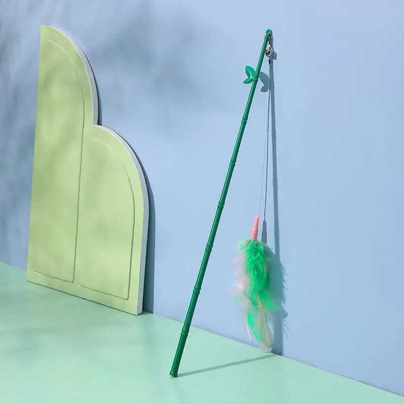 Green interactive cat feather wand toy with bells and feathers for indoor play and training