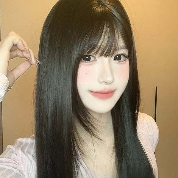 Dark brown long straight synthetic women's wig with a fringe on a wig head.