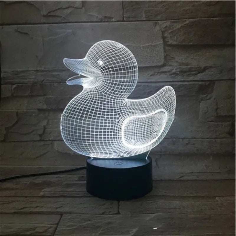 Little yellow duck 3D night light with colour-changing LED display on an ABS base, showing remote control.