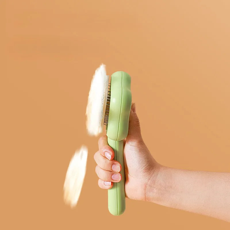 Magic wand cat comb with stainless steel needle teeth and self-cleaning mechanism in green colour