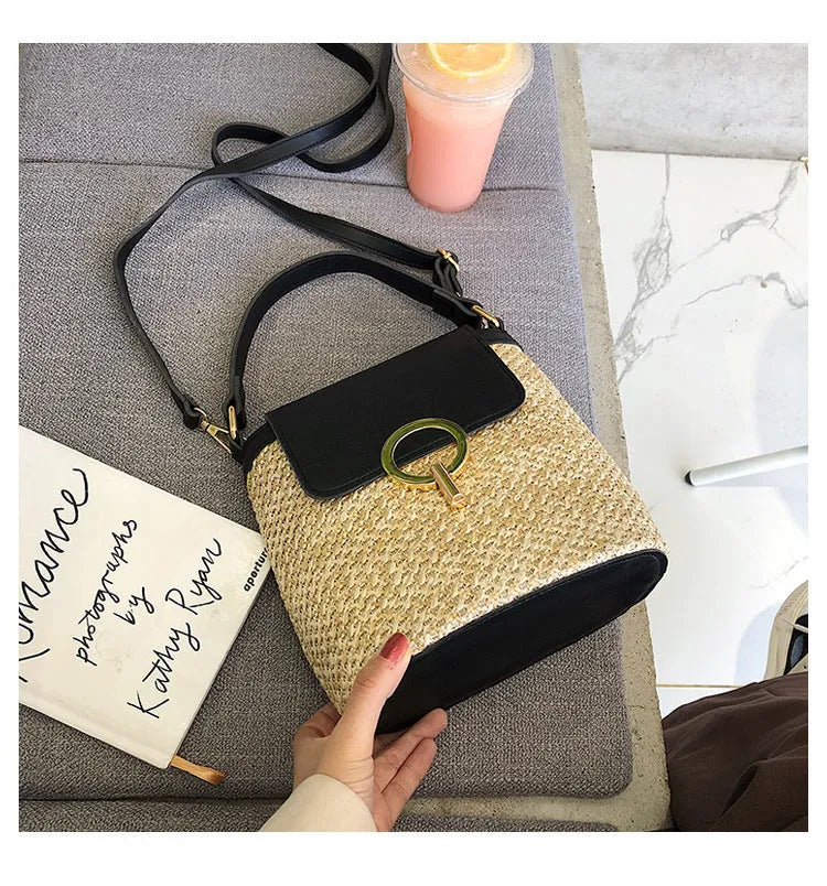 Women's straw woven bucket shoulder bag in black with cover flap, small size, polyester lining