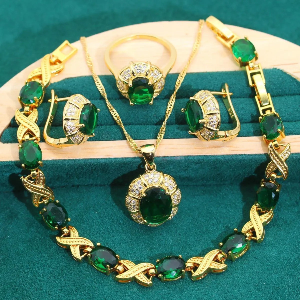 Gold plated cubic zirconia jewellery set with necklace, earrings, ring, and bracelet in blue, green, purple, or red.