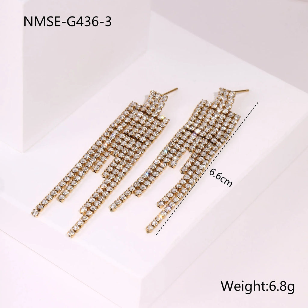 Gold electroplated stainless steel earrings with heart, star, and geometric shapes and a diamond tassel pendant.